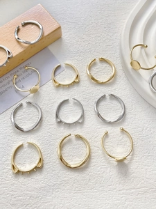 Detailed close-up of 14k gold plated and silver rings featuring minimalist cat ear designs