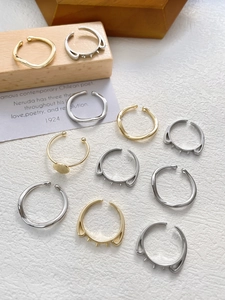 Macro shot of 14k gold and silver DIY ring settings featuring cat ear and wave designs