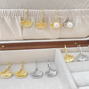 Ginkgo leaf earrings hooks in gold and silver finish with elegant white pearl accents