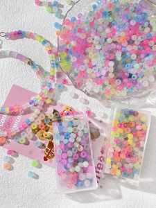 Macro shot of colorful pastel macrame beads kit for DIY jewelry with organizer box