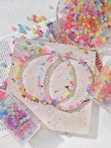 Detailed view of colorful frosted bead necklaces and bracelets with metallic clasps