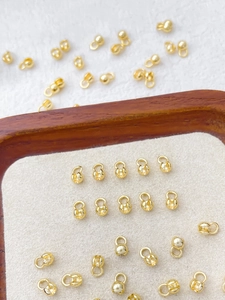 Macro detail of 14k gold-plated jewelry clasps and connectors for DIY necklaces