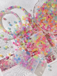 Macro view of colorful macaron glass seed beads set for DIY jewelry making in storage box