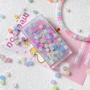 Macro shot of macaron frosted seed beads in a clear box for DIY jewelry making sets