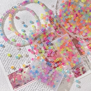 DIY jewelry kit with colorful matte translucent beads in a clear storage box
