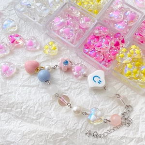 Y2K colorful beaded bracelet with pink resin hearts and star pendant on white paper