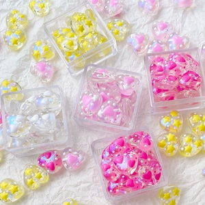 Macro shot of colorful heart-shaped acrylic beads with star patterns for DIY jewelry