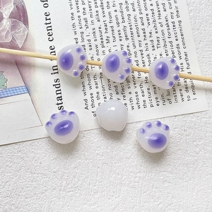 Detail of cute cat paw beads with purple pads for DIY jewelry and phone chain making