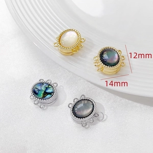 Macro detail of 12mm and 14mm magnetic shell clasps in gold and silver for jewelry