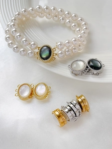 Close-up of gold-plated oval clasp with white shell inlay for double-row pearl necklaces