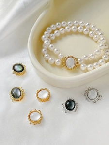 Macro detail of gold plated pearl magnetic clasp with mother of pearl inlay for DIY jewelry