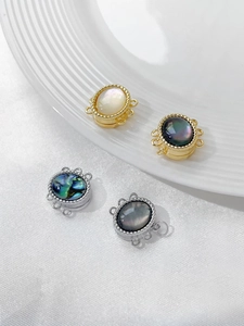 Close-up of multi-strand magnetic jewelry clasps with shell inlay and gold plating