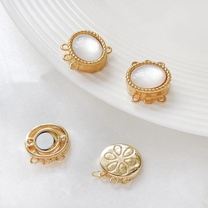 Detailed macro view of 3-hole gold magnetic clasps with white shell inlay for DIY jewelry