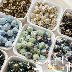 Macro detail of 12mm ceramic pumpkin beads with floral glaze and 2.3mm hole for DIY jewelry