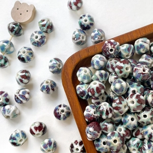 Macro shot of kiln-fired ceramic pumpkin beads for DIY jewelry with unique reactive glaze