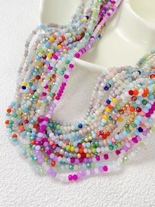 Vue macro de perles en cristal facetté colorées sur un plateau en céramique pour bijoux DIY