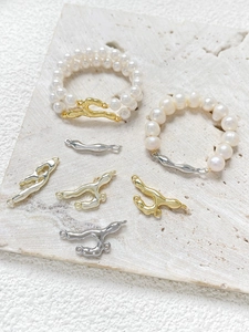 Detail of liquid metal style gold and silver connectors for DIY jewelry making