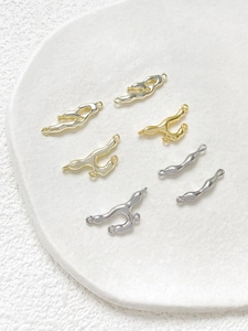 Macro view of gold and silver irregular fluid lava connectors for DIY jewelry making