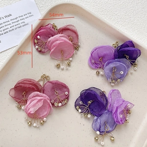 Detail of handmade gauze flower pendants with pearls and golden bells, 54mm size