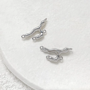 Macro detail of liquid metal style silver-plated three-ring connectors for DIY jewelry making