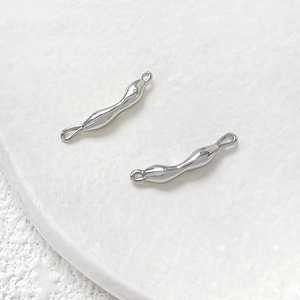 Macro shot of silver irregular streamline metal link connectors for DIY jewelry making