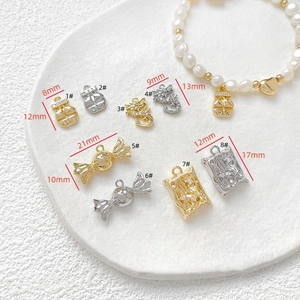 Detailed view of DIY 18k gold plated dragon and candy pendants with micro zircon inlay