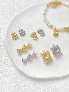 Macro shot of 18k gold plated dragon and candy pendants with micro-set zircon stones