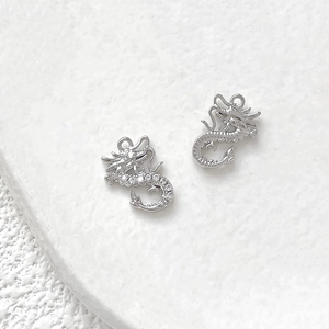 Macro view of 18k gold-plated dragon charms with micro-pave cubic zirconia stones