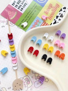 Macro shot of colorful resin smiley face beads for DIY jewelry and beaded accessories