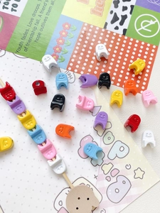 Macro view of colorful plastic smiley face charms for DIY jewelry and beaded crafts