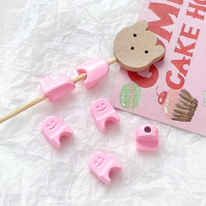 Detail of pink resin smiley face U-shape clip beads for DIY jewelry making kits