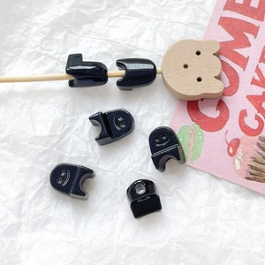 Macro view of black glossy smile face beads for DIY jewelry and beaded accessories