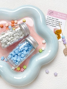 Detailed view of macaron flower beads in blue and white for DIY handmade jewelry
