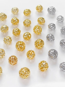 Macro shot of 14k gold and silver plated hollow geometric spacer beads for DIY jewelry
