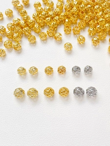 Macro shot of 14k gold-plated hollow mesh beads for DIY jewelry making and bracelet design