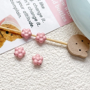 Macro detail of pink flower resin beads with glossy finish for DIY jewelry making