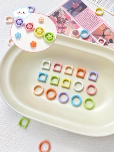 Macro view of macaron colored square and round resin spacer beads for DIY jewelry making