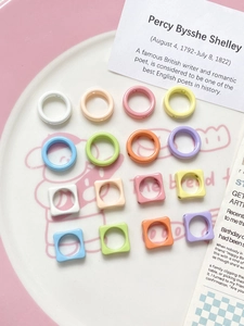Close-up of colorful macaron flower beads and square spacers for DIY jewelry making