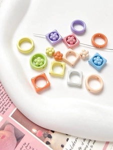 Macro shot of candy-colored resin flower and square beads for DIY jewelry making