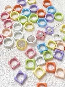 Macro shot of colorful macaron flower and square resin beads for DIY bracelet making