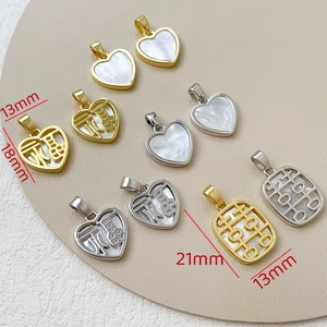 Close-up of 14k gold plated heart and rectangle pendants with mother of pearl and FU character