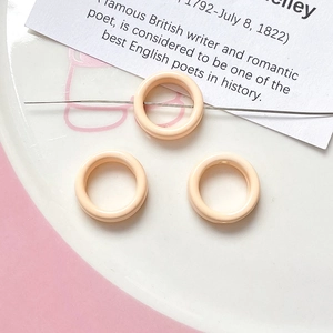 Macro detail of peach flower-shaped spacer beads for DIY jewelry and necklaces