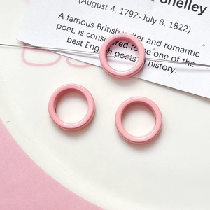 Macro shot of pink enamel ring beads for DIY jewelry making and bracelet accessories