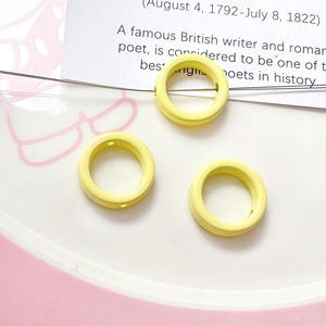 Detailed macro view of yellow macaron floral spacer beads for DIY jewelry making crafts
