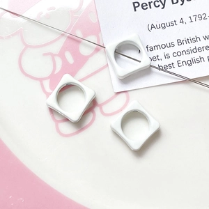 Macro shot of white square beads with round holes for DIY necklace and bracelet crafting