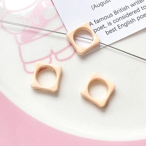 Macro view of macaron flower square resin beads for DIY jewelry making and handmade crafts