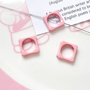 Macro detail of pink macaron flower square beads for DIY necklace and bracelet jewelry