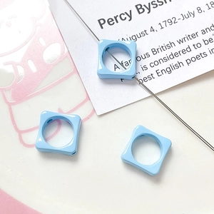 Macro shot of light blue square floral spacer beads with large holes for DIY jewelry
