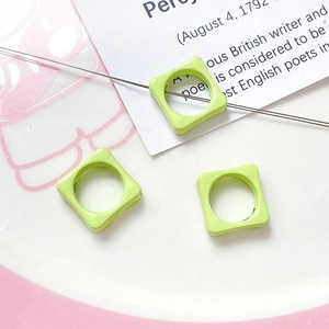 Macro detail of square light green macaron beads for DIY jewelry making and crafts