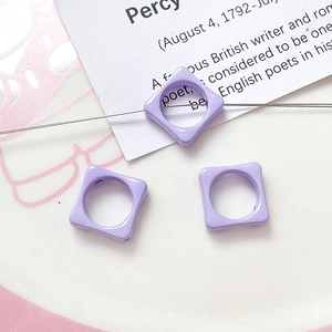 Macro detail of lavender square flower spacer beads for DIY jewelry making
